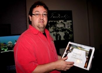 Michael Everett, co-owner of The Creation Lab, showing an example of the Turlock Film Commission location and services directory.