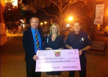 Turlock firefighters presented a big pink check in the amount of $17,000 to Emanuel Medical Center representatives after a month-long pink t-shirt fundraiser. 11-13-12