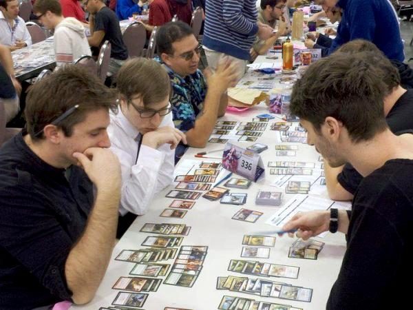 Jason Gulevich, bottom left, plays a game of Magic: the Gathering.